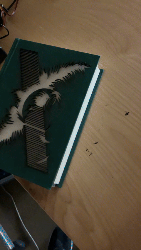 Electroluminescent dust jacket in motion
